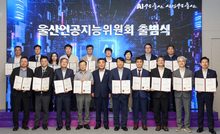 울산시가 '인공지능(AI) 수도' 도약을 위한 본격적인 행보로 12일 울산시청 대회의실에서 '울산인공지능위원회 출범식'과 함께 제1차 회의를 열었다. 김두겸 울산시장이 울산정보산업진흥원, 울산과학기술원(UNIST), 한국전자통신연구원(ETRI), 울산대, 한국생산기술연구원, 울산상공회의소, 에스케이(SK)텔레콤 관계자 등 산·학·연·관 전문가 및 대표들에 위촉장을 수여하고 기념촬영을 하고 있다. 이수화 기자