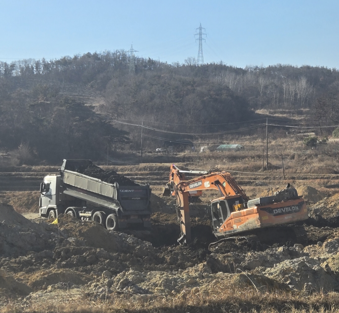 울산 북구 상안동 1002번지 일원에 불법성토가 의심되는 민원이 수차례 제기돼 논란이다. 지난해 12월 굴삭기가 파낸 땅에 화물차가 검은색 흙을 붓고 있다. 독자 제공