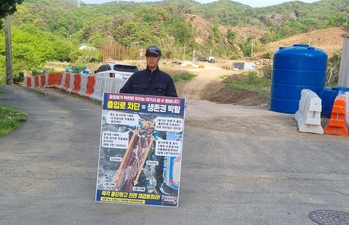 울산 북구 산음마을 주민이 강동~농소 도로개설공사에 따른 마을 진출입로 폐쇄를 우려하며 공사 현장 앞에서 1인 시위를 하고 있다.
