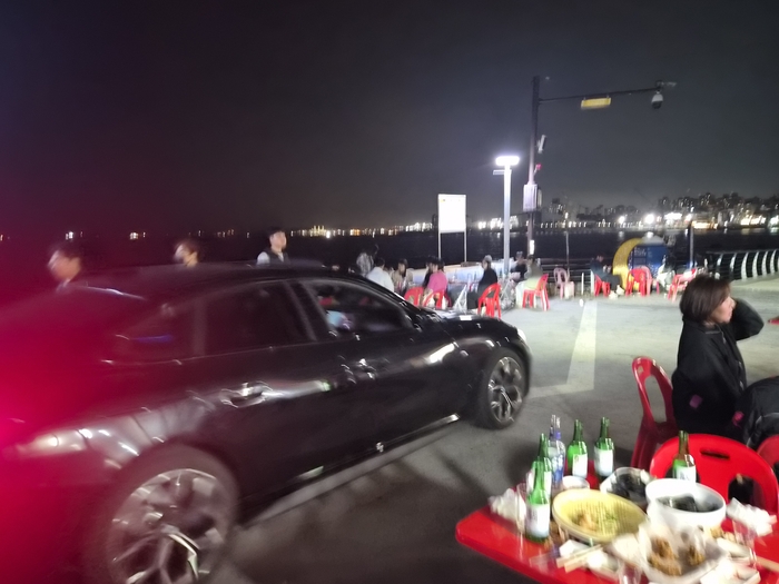울산 동구의 한 인기 야장 테이블 사이로 차량 한 대가 아슬아슬하게 통행하고 있다. 김귀임 기자